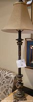 Single buffet lamp with brass-look metal base and beige fabric shade, showing height and details
