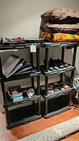 Photo of two black resin/plastic heavy-duty adjustable storage shelving units with various items placed on shelves.