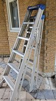 Side angle view of the aluminum five-step ladder showing structure and steps.