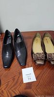 Photo showing both pairs of women's flats on wooden surface
