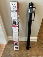 Photo showing boxed and unboxed retractable safety gate with packaging and product info