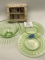 Full view of lot showing 5 VMC Reims France vintage car shot glasses in original box (1 glass missing) alongside 2 uranium pressed glass plates and 1 small bowl