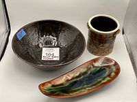 Photo of all three pottery pieces: bowl, vase, and boomerang plate, showing shape, color, and condition.