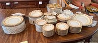 Full view of Noritake volume of plates, bowls, cups and serving dishes on a table.