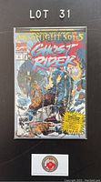 Photo of Ghost Rider 31 comic book sealed in plastic bag and board, showing full front cover with title, publisher logo, and prominent artwork.