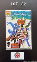 Photo of Marvel Spectacular Spider-Man comic issue #119, sealed in protective bag and backed by cardboard, showing cover art with Spider-Man and Sabretooth fight scene.