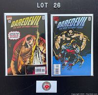 Two Daredevil comic books, issues 339 and 341 from 1995, each bagged and boarded on a black background with 'LOT 26' label above.