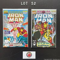 Two Iron Man annual comics displayed flat, bagged and boarded, with clear view of front covers. Issue #10 on left and issue #12 on right.