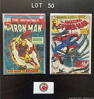 Photo showing front covers of two vintage Marvel comics: The Invincible Iron Man #71 and The Amazing Spider-Man #236, both bagged and boarded.