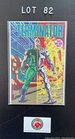 Photo of first issue comic book titled 'TERMINATOR', bagged and boarded, clear cover showing character half human half machine, labelled with 'First Issue' sticker on the front