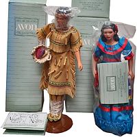 Both Avon porcelain dolls in original boxes with paperwork and display stands, dolls partially wrapped in plastic for protection.