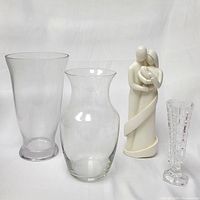 All 4 items displayed together on white background: 3 vases and 1 family statue