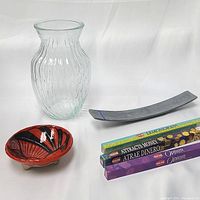 Clear glass vase, curved sandstone incense burner, Mexican ceramic bowl, and four incense packs shown