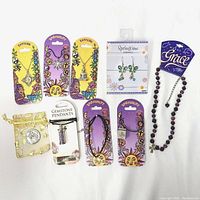 Top view of the entire lot showing assorted new jewelry cards with pendants, necklaces, and earrings including sun and moon motifs, butterfly earrings, amethyst stones.