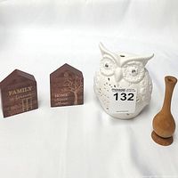 Photo showing all four items: two wooden plaques, white ceramic owl candle holder, and small wooden vase.