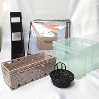 Photo showing collapsible fabric storage containers, plastic drawer organizers, vertical file holder, and small baskets