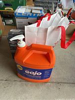 GoJo Natural Orange pumice hand cleaner container alongside other components in lot