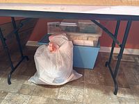 Photo showing the black resin folding table profile and bag underneath