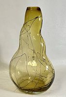Photo showing 12-inch amber smoked blown glass vase with abstract raised veined design and organic asymmetrical shape, viewed from the front.