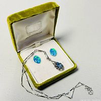 Gold plated choker necklace with aquamarine and marcasite pendant displayed in green velvet jewelry box with opal cabochon earrings