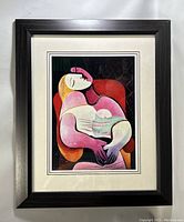 Full view of framed Picasso print with black wooden frame and double matting.