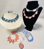 Overall view of all costume jewelry items included in the lot on display mannequins and stand.