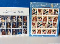 Photo showing two sheets of postage stamps: one with Classic American Dolls and another with Disney characters like Mickey Mouse and Bambi.