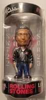 Front view of the Bobble Dobbles figurine of a Rolling Stones band member in packaging showing detailed face, clothing, and accessories.