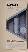 Front view of unopened Crest Whitening Emulsions box showing the bottle inside along with the 1-minute apply and go application instruction.