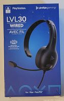 Front view of PDP Gaming LVL30 wired chat headset box showing branding, 30mm drivers, and PS4 compatibility.