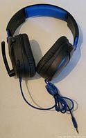 Turtle Beach Recon 70 gaming headset showing ear cups, microphone, and wired connection.