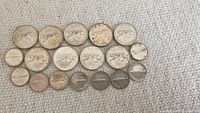 All 18 coins including 9 dimes and 9 quarters arranged on a fabric surface showing front sides.