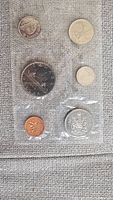 Photo showing six Canadian coins from 1968 in a plastic protective sleeve.