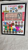 Front overall view of the framed Canadian commemorative set showing the $2 bill, coins, and provincial crests map.