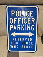 Front view of blue and white Police Officer Parking tin sign with embossed text and arrows.