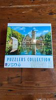 Front of the puzzle box showing the scenic castle image and 'Puzzlers Collection 750' text.