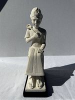 Front view of the alabaster statue showing the pharaoh figure with headdress and staff.