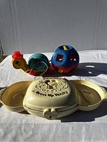 The Fisher Price Dress Up Vanity toy closed with turtle pull toy and shape sorter ball behind