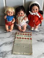 Three dolls displayed with original Furga pamphlet.