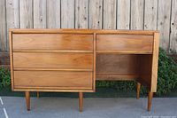 Full frontal view of walnut desk showing drawer configuration and leg style