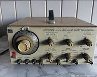 Front left angle view showing frequency multiplier dial and control knobs.