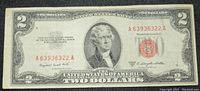 Front side of 1953 B Series United States $2 dollar bill showing Thomas Jefferson portrait, red seal and serial numbers.