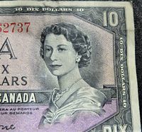 Close-up of Queen Elizabeth II portrait and denomination on the front right side of the note showing wear and detail.