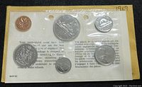 Photo of 1969 Canadian sealed uncirculated coin set front showing six coins sealed in plastic with yellow backing and bilingual text.