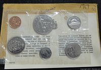 Rear side view of the sealed 6 coin set showing the reverse side designs including Canadian maple leaf and other national symbols.