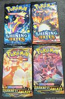 Front view of four sealed Pokémon booster packs showing label and artwork