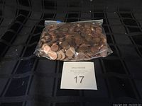 Clear plastic bag filled with mixed Canadian and USA pennies, weighed approximately 56 ounces.