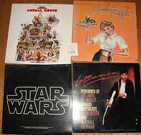 Four vintage movie soundtrack records: Animal House, American Graffiti, Star Wars, and La Bamba, arranged in a 2x2 grid showing cover art.