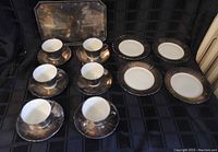 Full set showing 6 cups with saucers, 6 plates, and 1 large platter all with sterling silver plating.