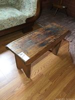 Top and angled view of the antique wooden bench showing heavily worn surface and aged patina.